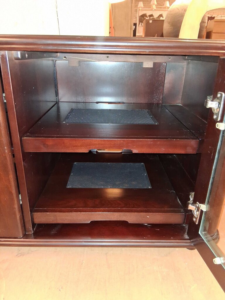 Wooden cabinet with open doors showing interior shelves.