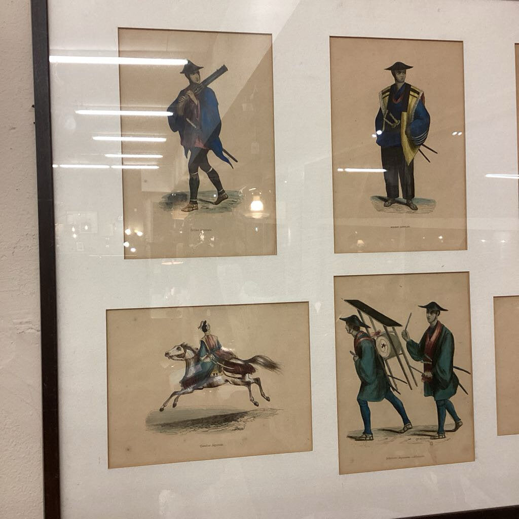 Set of four framed illustrations of historical figures on a wall.
