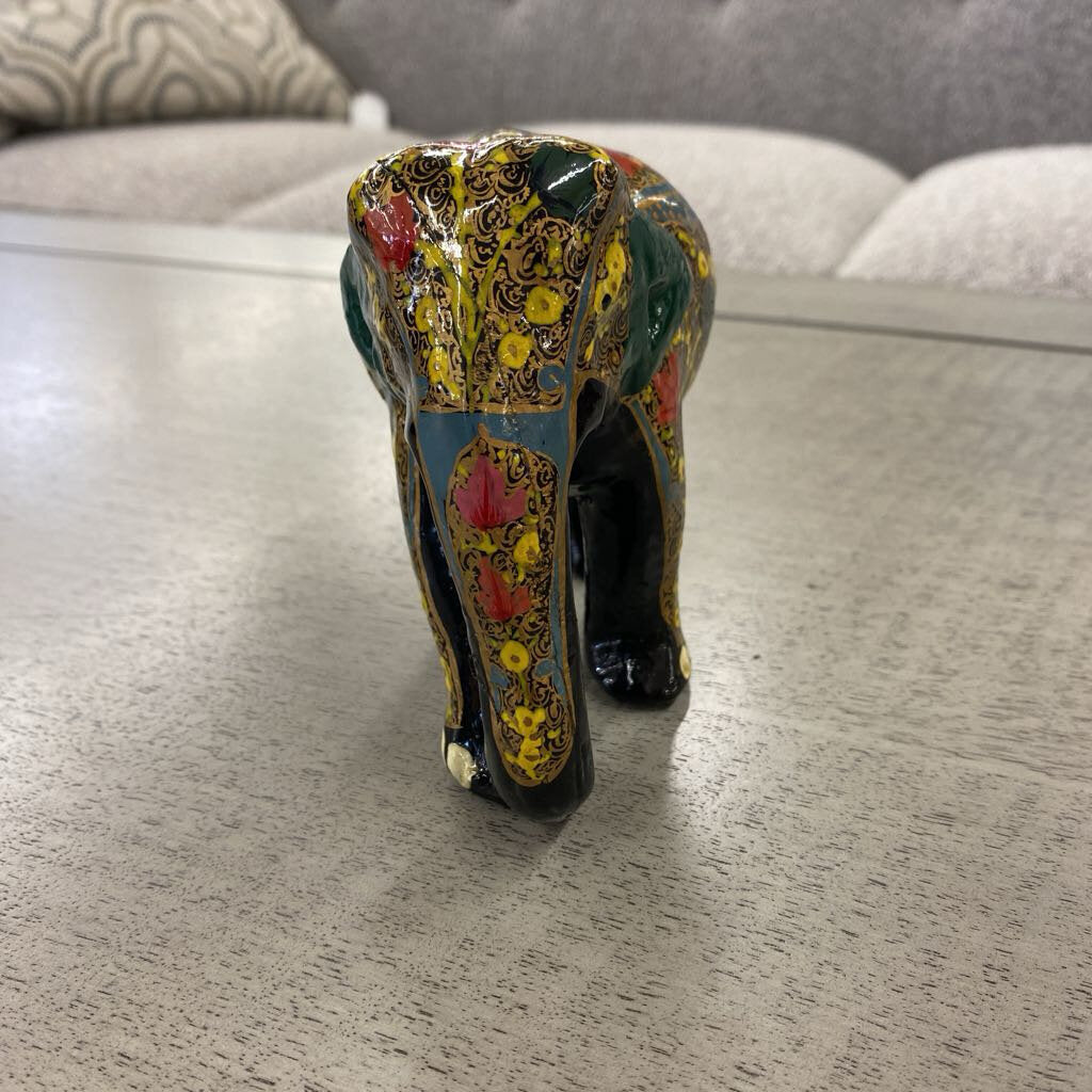 Colorful elephant figurine on a wooden surface