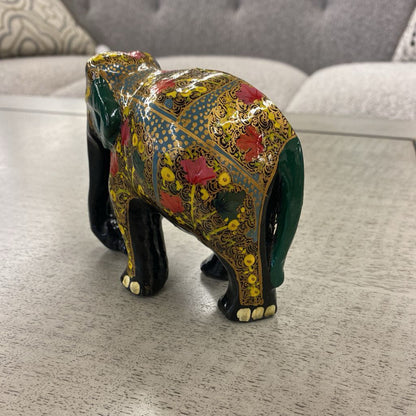 Decorative elephant figurine with intricate patterns on a wooden surface