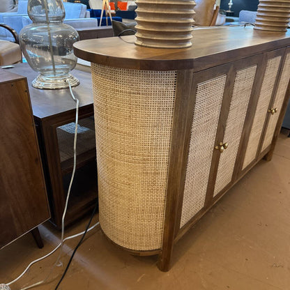 Wooden sideboard with wicker paneling in a room setting