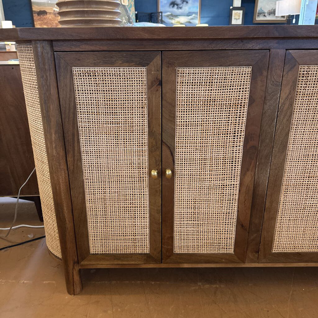 Wooden cabinet with wicker doors on a wooden floor