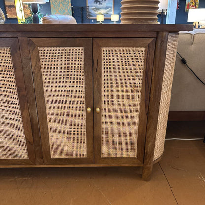 Wooden cabinet with wicker doors in a room setting