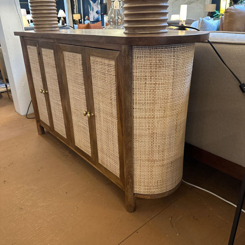 Wooden sideboard with wicker doors in a room setting