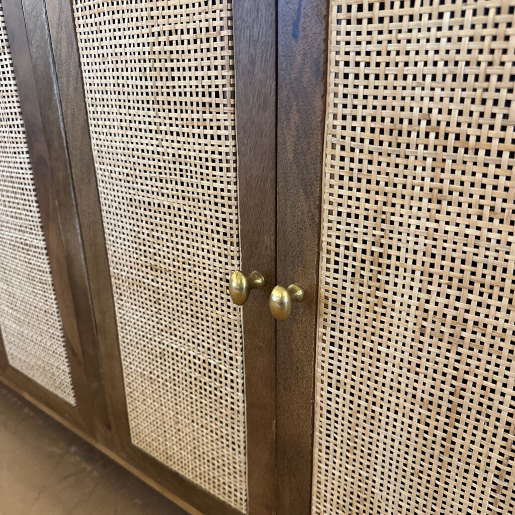 Wooden cabinet with rattan doors and brass handles