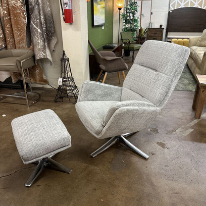 Gray swivel chair with ottoman in a showroom setting
