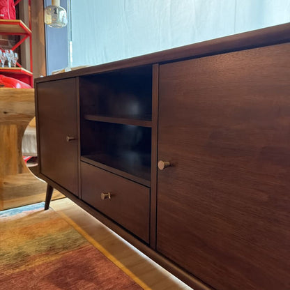Wooden sideboard with glass doors in a room setting
