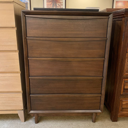 Wooden dresser with four drawers in a room setting