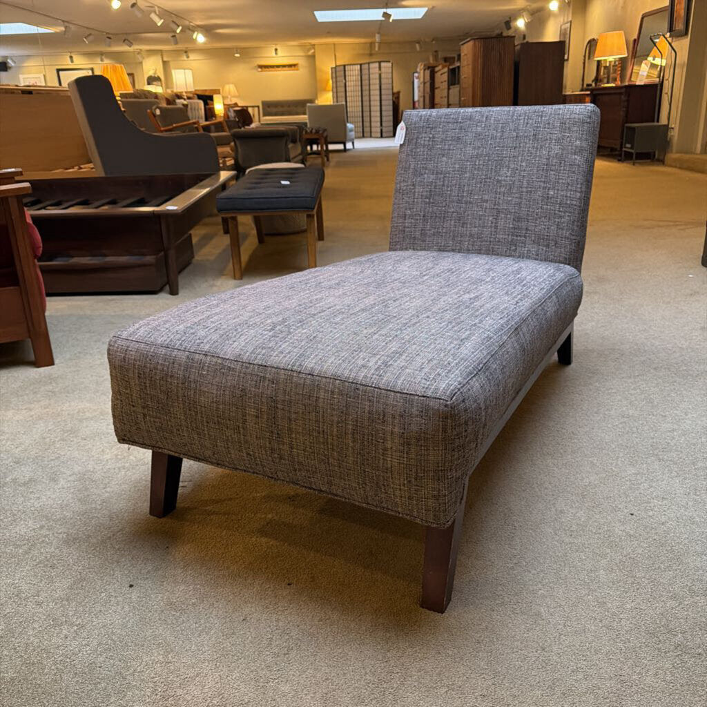 Gray upholstered chair in a furniture store setting