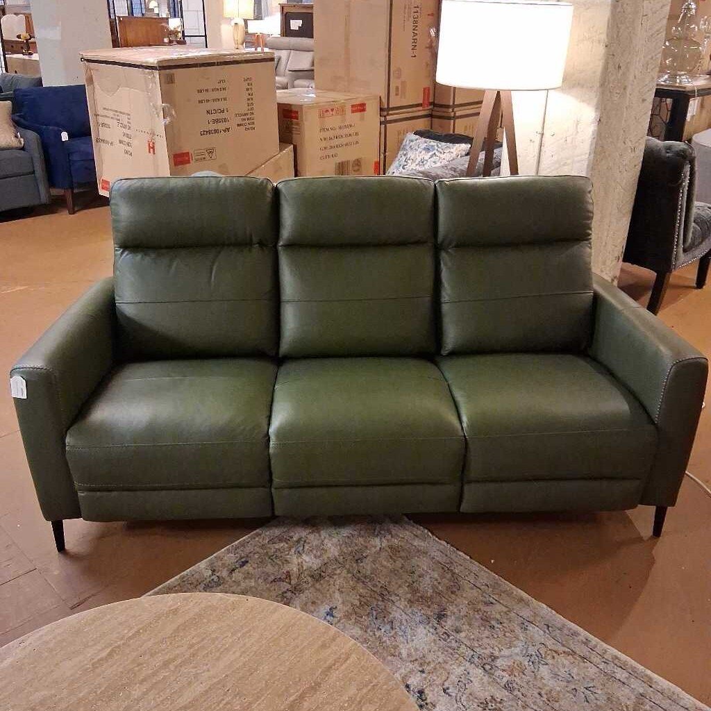 Green leather sofa in a room with boxes and furniture.