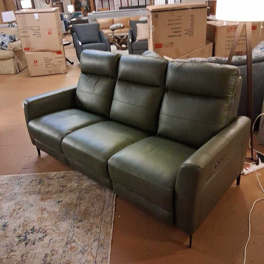 Green leather sofa in a room with boxes and furniture