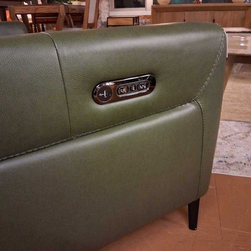 Green leather sofa with control panel in a room setting