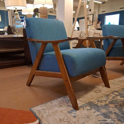 Blue armchair with wooden frame in a store setting
