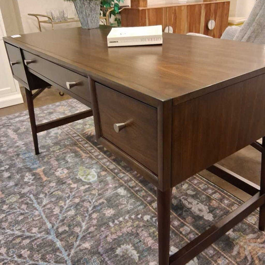 Wooden desk with drawers on a patterned rug