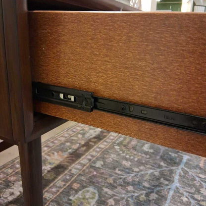 Brown wood writing desk with drawers