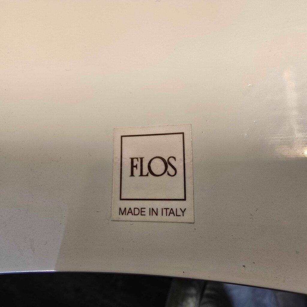 FLOS logo on a metallic surface with 'MADE IN ITALY' text