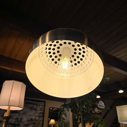 Ceiling light fixture with perforated design in a dimly lit room