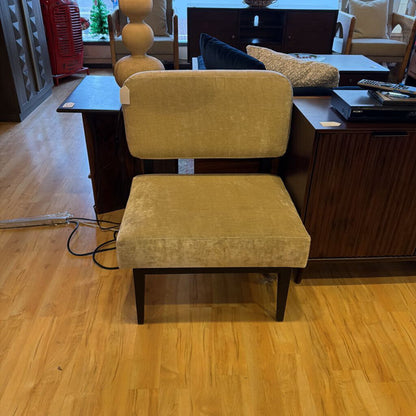 Yellow chair on a wooden floor with a blurred background