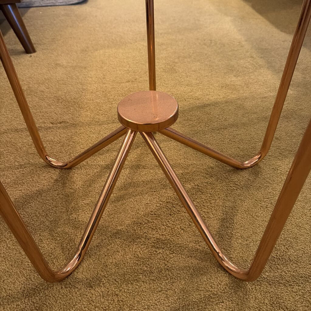 Copper metal stand on a carpeted floor