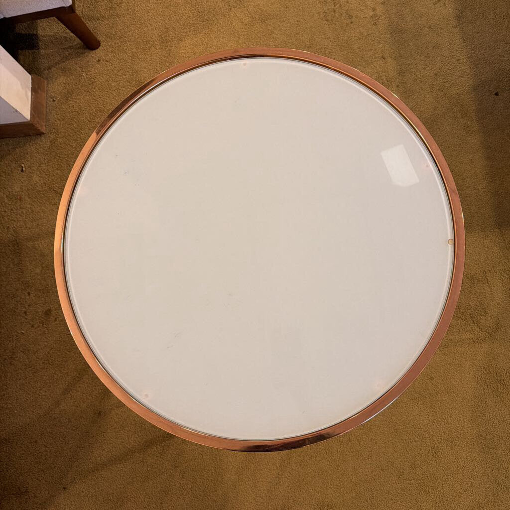 Round glass table with wooden frame on a brown carpet