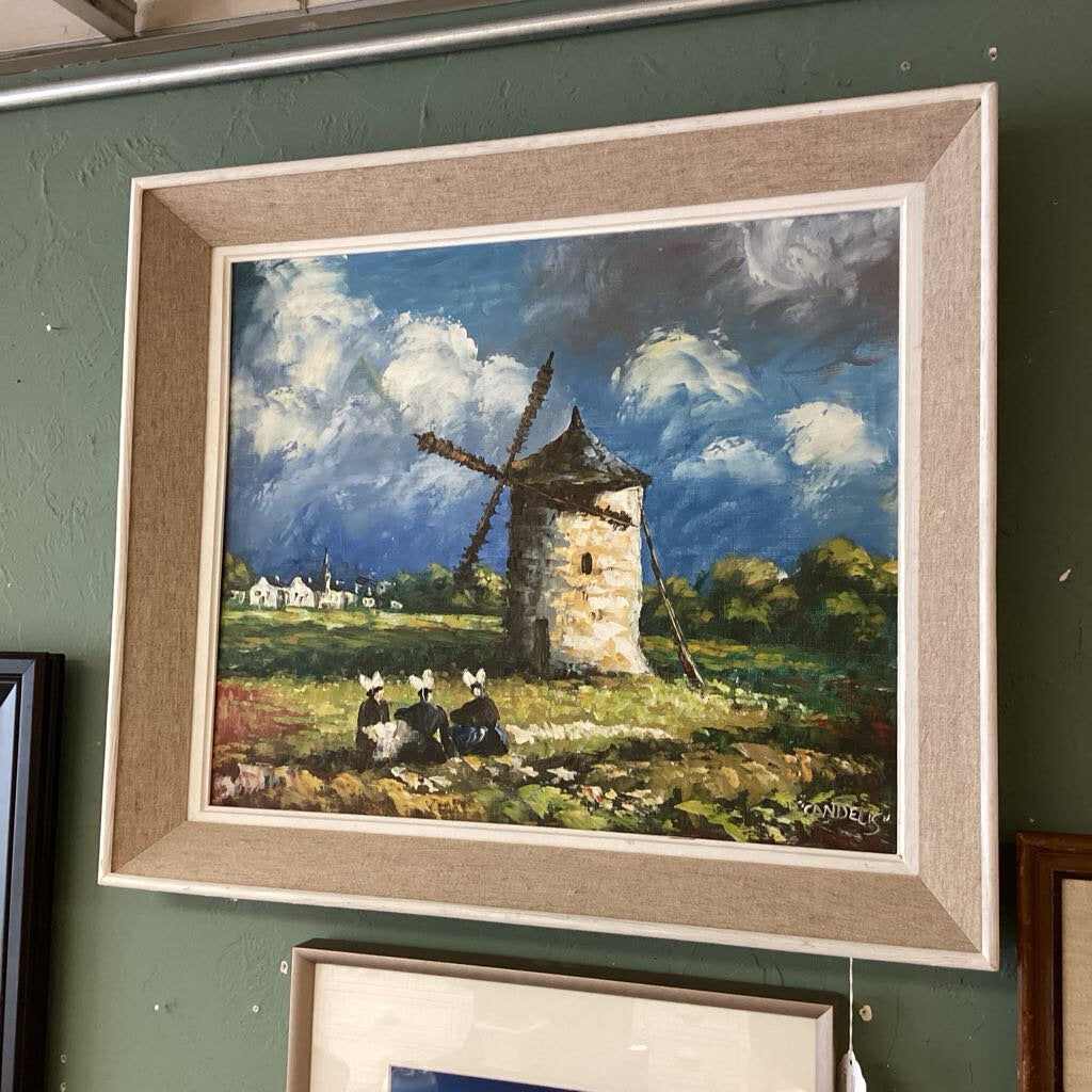 Framed painting of a windmill scene on a green wall