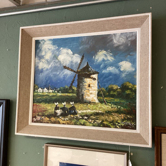 Framed painting of a windmill scene on a green wall