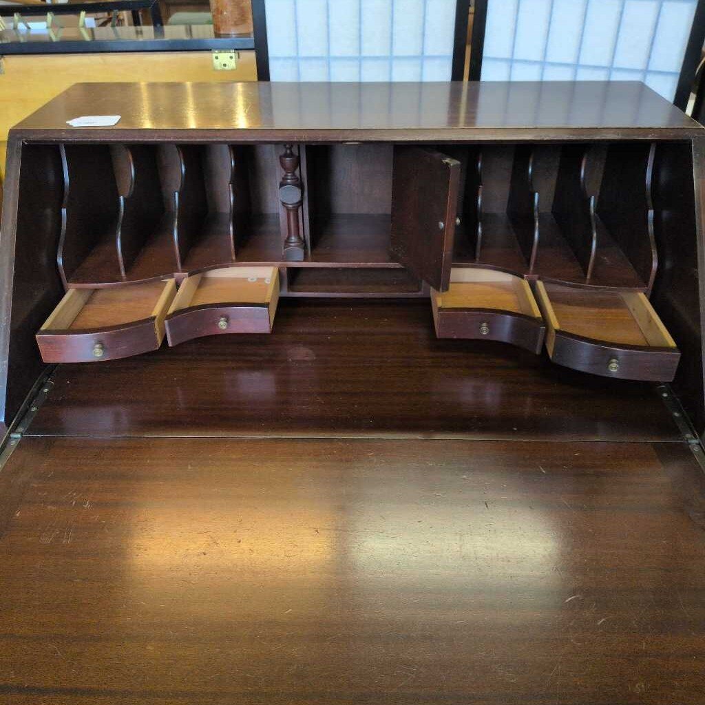 Wooden desk with multiple drawers and open compartments
