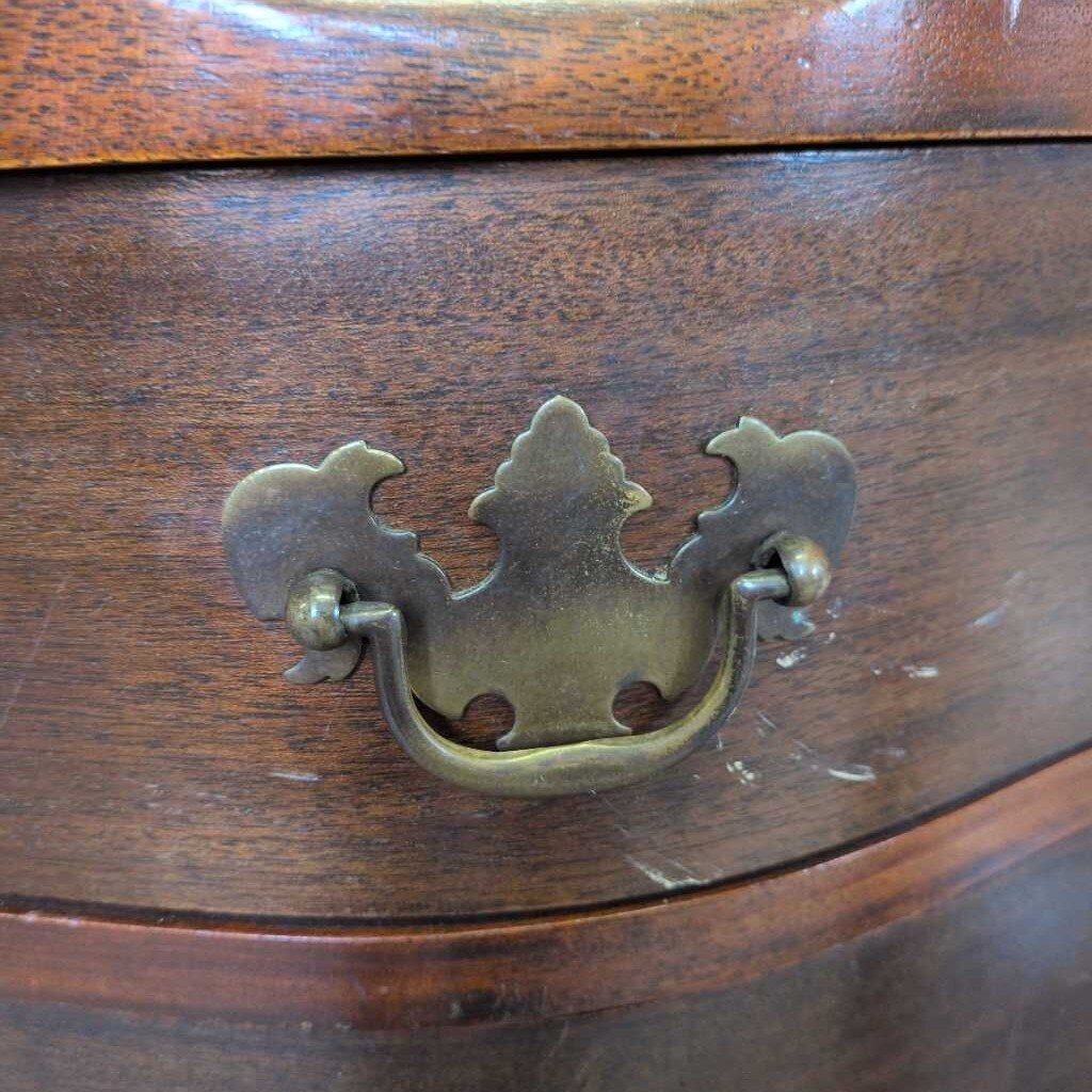 Wooden drawer with a decorative brass handle