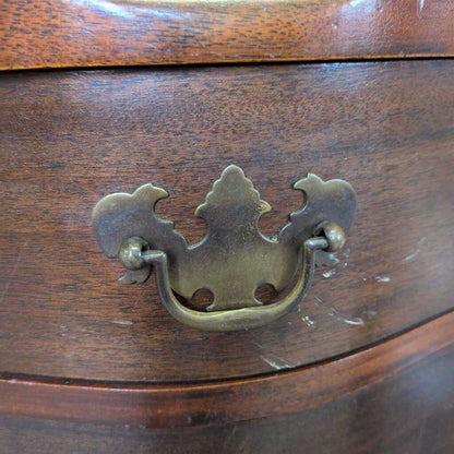Wooden drawer with a decorative brass handle