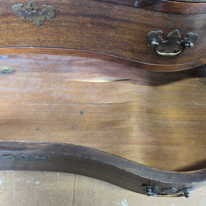 Wooden furniture with brass handles on a wooden floor