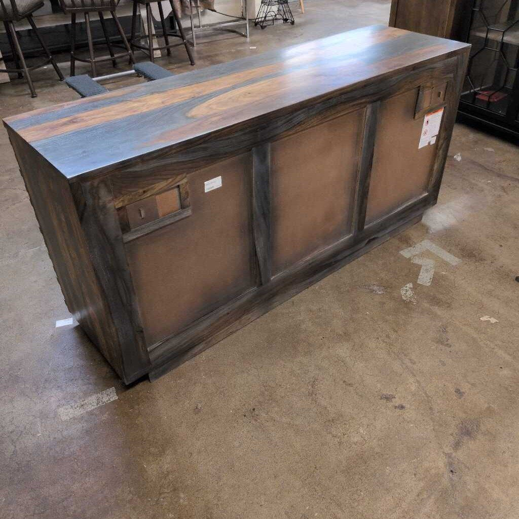 Wooden console table with a dark finish on a concrete floor