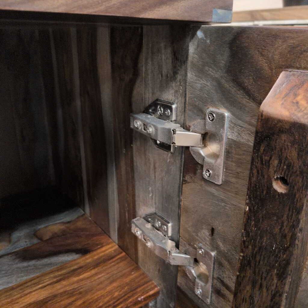Close-up of wooden furniture with metal hinges