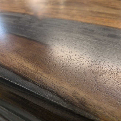 Close-up of a wooden surface with a dark brown finish