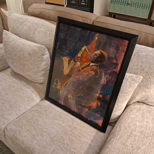 Framed abstract painting on a beige sofa