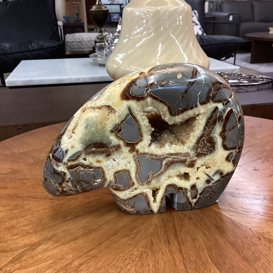 Marble-like stone on a wooden surface with a blurred indoor background