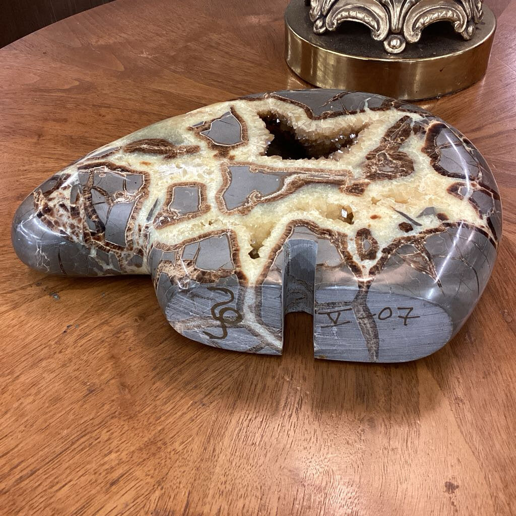 Polished stone with natural patterns on a wooden surface