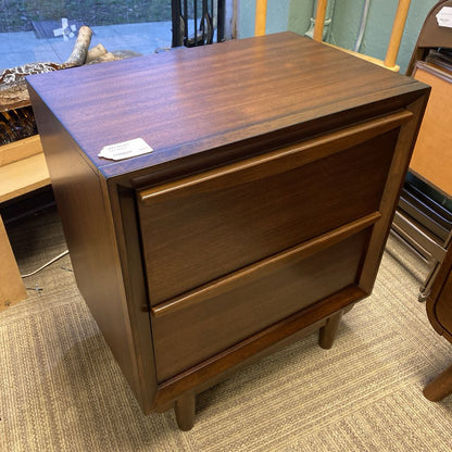 Wooden nightstand with a single drawer in a room setting