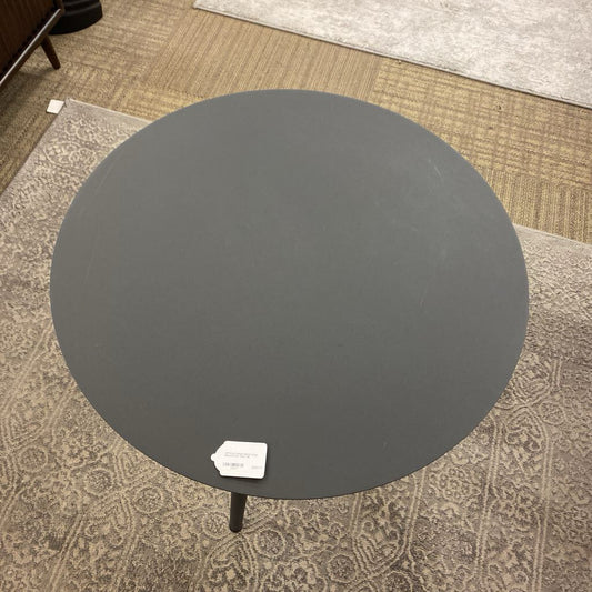 Round black table on a patterned carpet