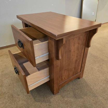 Wooden desk with open drawers on a carpeted floor