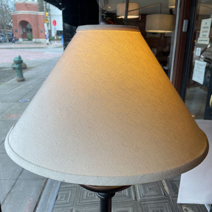 Beige lampshade on a stand with a city street background