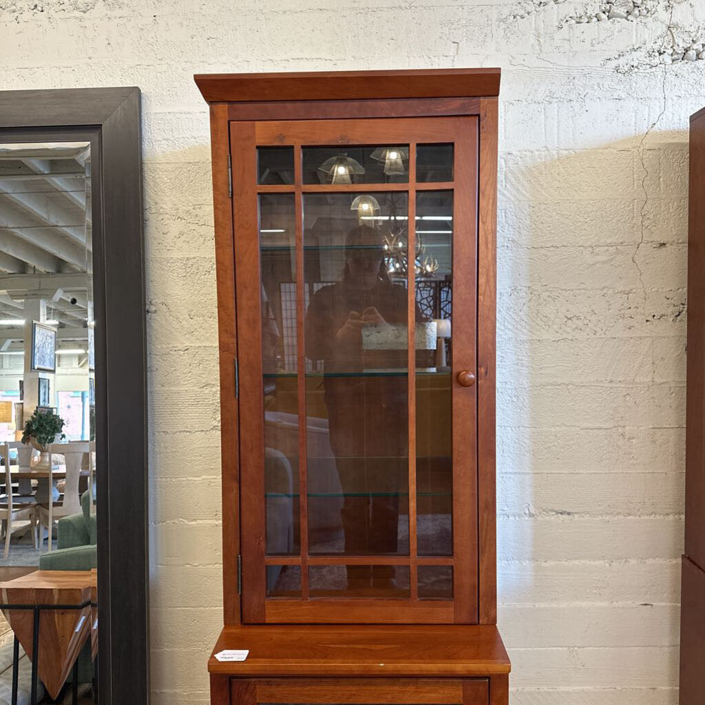 Wooden cabinet with glass doors in a room setting