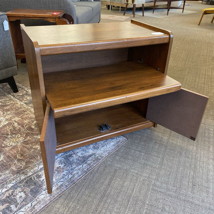 Wooden shelf with open doors on a carpeted floor