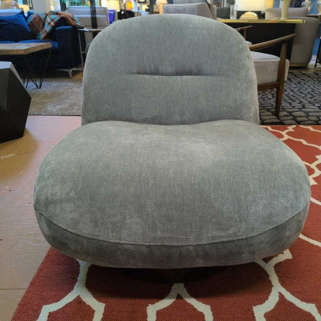 Gray armchair in a room with a patterned rug