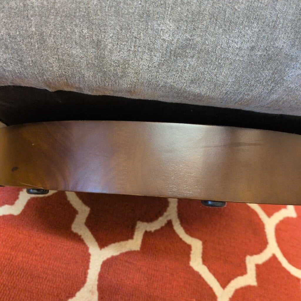 Wooden table with a black strap on a red and white patterned surface