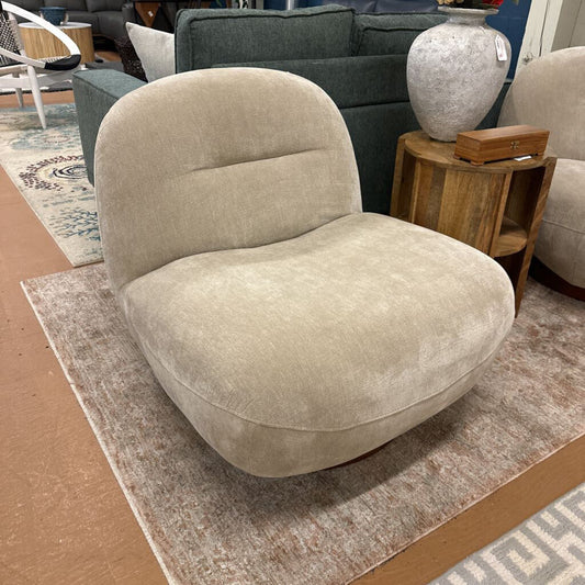 Beige armchair in a room with a rug and furniture