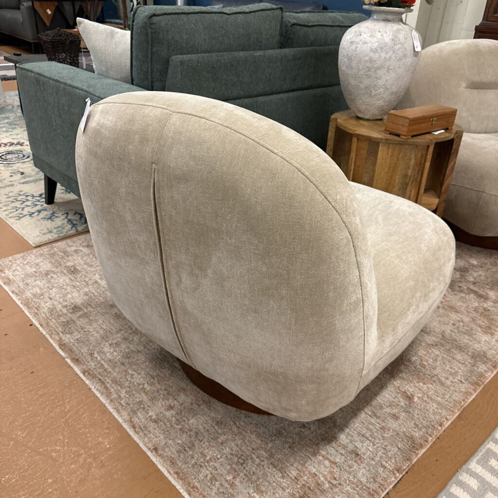 Beige armchair in a room with other furniture and decor