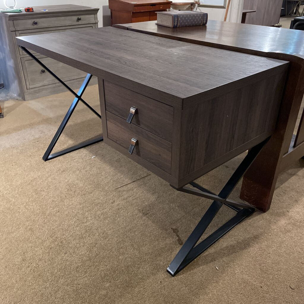 Wooden desk with metal legs on a beige carpeted floor