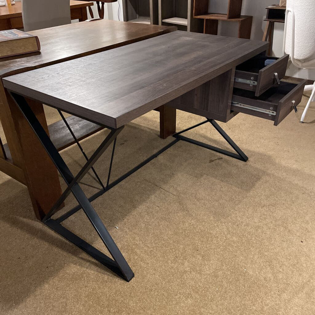 Wooden desk with metal legs on a beige floor