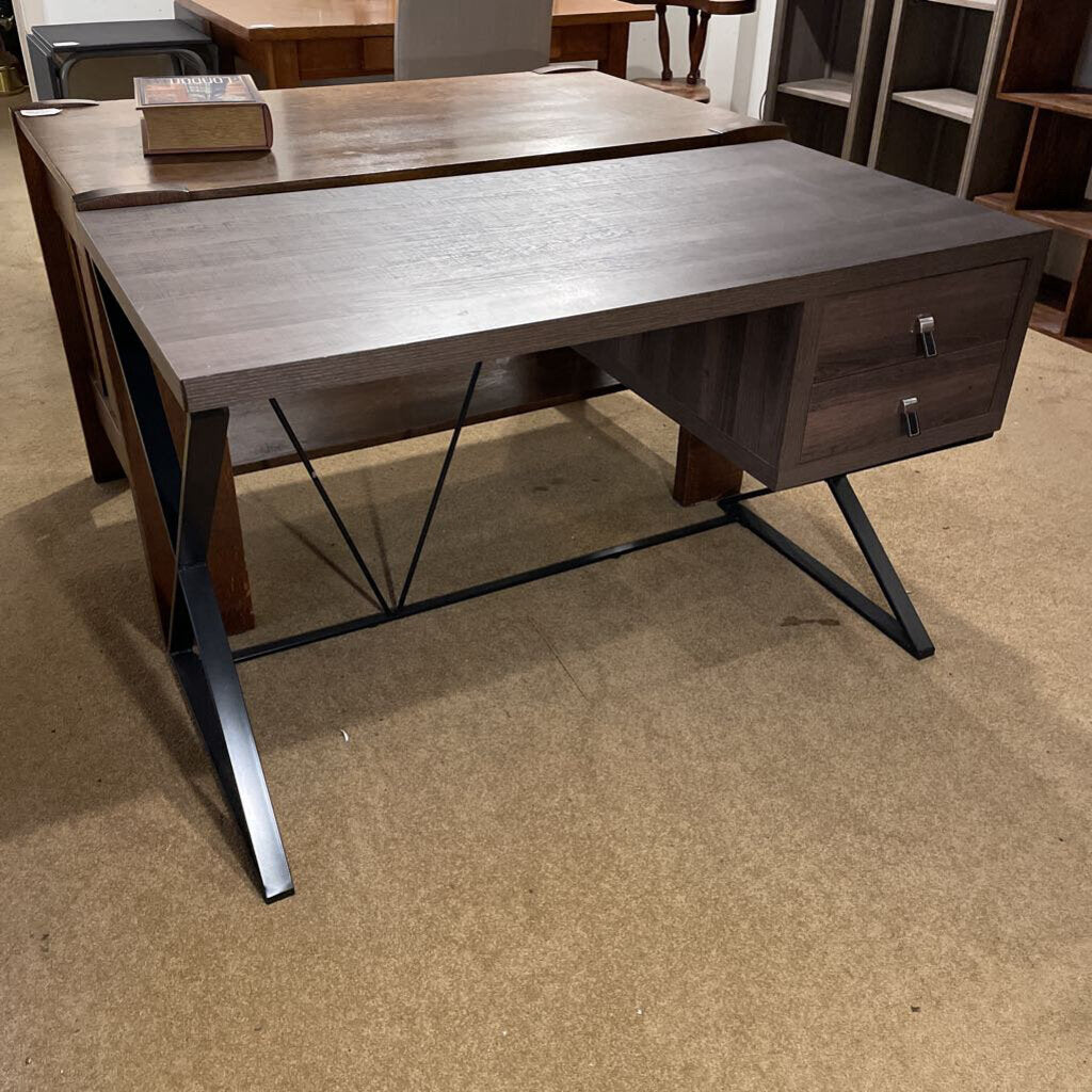 Wooden desk with metal legs on a beige carpeted floor
