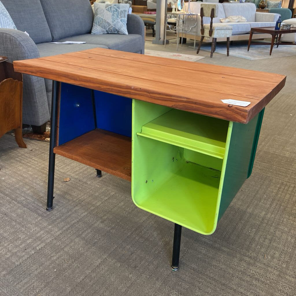Wooden table with green storage unit on a carpeted floor